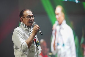 Malaysian Prime Minister Anwar Ibrahim speaks during a rally to show support for Palestinian people in Kuala Lumpur, Malaysia, Tuesday, Oct. 24, 2023. Thousands of Malaysians, dressed in white, gathered at a stadium to show solidarity for the Palestinians.