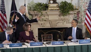 Barack Obama smiles as he wait for Joe Biden to take his seat at the Blair House in Washington. Seated, from left are Harry Reid and Nancy Pelosi