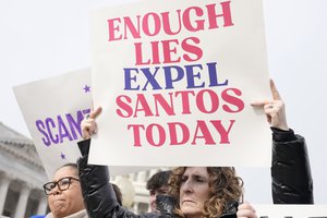 Constituents from the district of Rep. George Santos, R-N.Y., hold signs during the news conference outside the U.S. Capitol