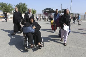 Palestinians cross to the Egyptian side of the border crossing with the Gaza Strip Wednesday, Nov. 1, 2023. in Rafah Wednesday, Nov. 1, 2023.