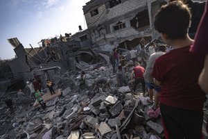 Palestinians look for survivors of the Israeli bombardment in the Maghazi refugee camp in the Gaza Strip, Sunday, Nov. 5, 2023.