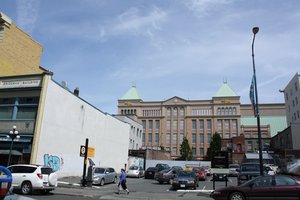 Cars are parked at a parking space surrounded by commercial buildings in downtown Victoria, British Columbia, Canada on June 12, 2011.