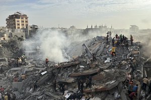 FILE - Palestinians look for survivors following Israeli airstrike in Nusseirat refugee camp, Gaza Strip, Oct. 31, 2023. Americans have become more likely to describe Israel as an ally that shares U.S. interests and values since the war with Hamas began, but they're divided over whether Israel has gone too far in its response to last month's attack, according to a new poll from The Associated Press-NORC Center for Public Affairs Research.