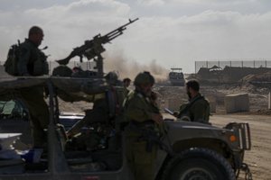 Israeli army troops are seen on the Israeli-Gaza border during a ground operation in the Gaza Strip, Wednesday, Nov. 8, 2023