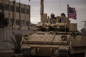 American soldiers patrol near prison that was attacked by the Islamic Stete militants in Hassakeh, Syria, Tuesday, Feb. 8, 2022