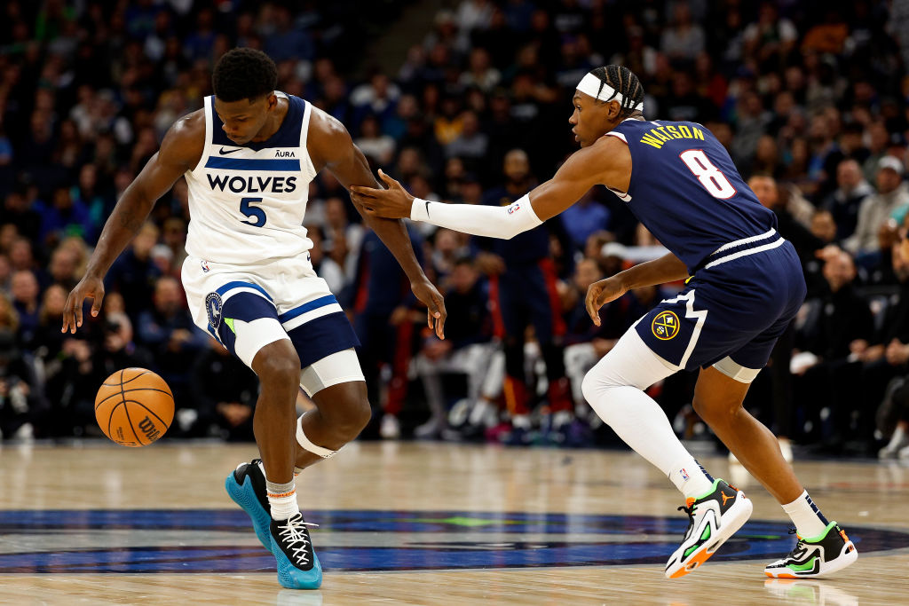 Slideshow-image: MINNEAPOLIS, MINNESOTA - NOVEMBER 01: Anthony Edwards #5 of the Minnesota Timberwolves dribbles the ball while Peyton Watson #8 of the Denver Nugge...