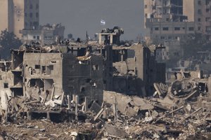 An Israeli flag stands on the top of a destroyed building in the Gaza Strip, as seen from southern Israel, Wednesday, Nov. 15, 2023.