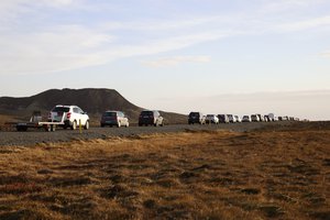 A line of cars queued on a road heading to the town of Grindavik, Iceland Monday Nov. 13, 2023. Residents of Grindavik, a town in southwestern Iceland, have been briefly allowed to return to their homes on Monday after being told to evacuate on Saturday after increasing concern about a potential volcanic eruption caused civil defense authorities to declare a state of emergency in the region.