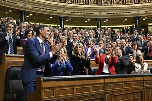 Spain's acting Prime Minister Pedro Sanchez, left, applauds with socialist deputies after he was chosen by a majority of legislators to form a new government after a parliamentary vote at the Spanish Parliament in Madrid, Spain, Thursday, Nov. 16, 2023