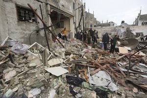 Palestinians look at destruction after Israeli strikes on Rafah, Gaza Strip, Wednesday, Nov. 15, 2023. As the military sets its sights on southern Gaza in its campaign to stamp out Hamas, key challenges loom. International patience for a protracted invasion has begun to wear thin.