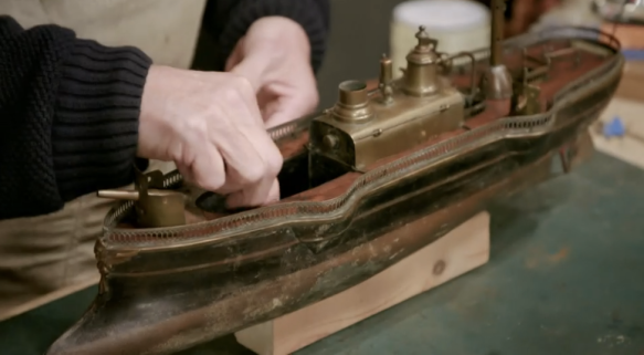 Steven Fletcher works on a toy battleship in The Repair Shop