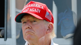 Donald Trump wears a "Make America Great Again" hat.