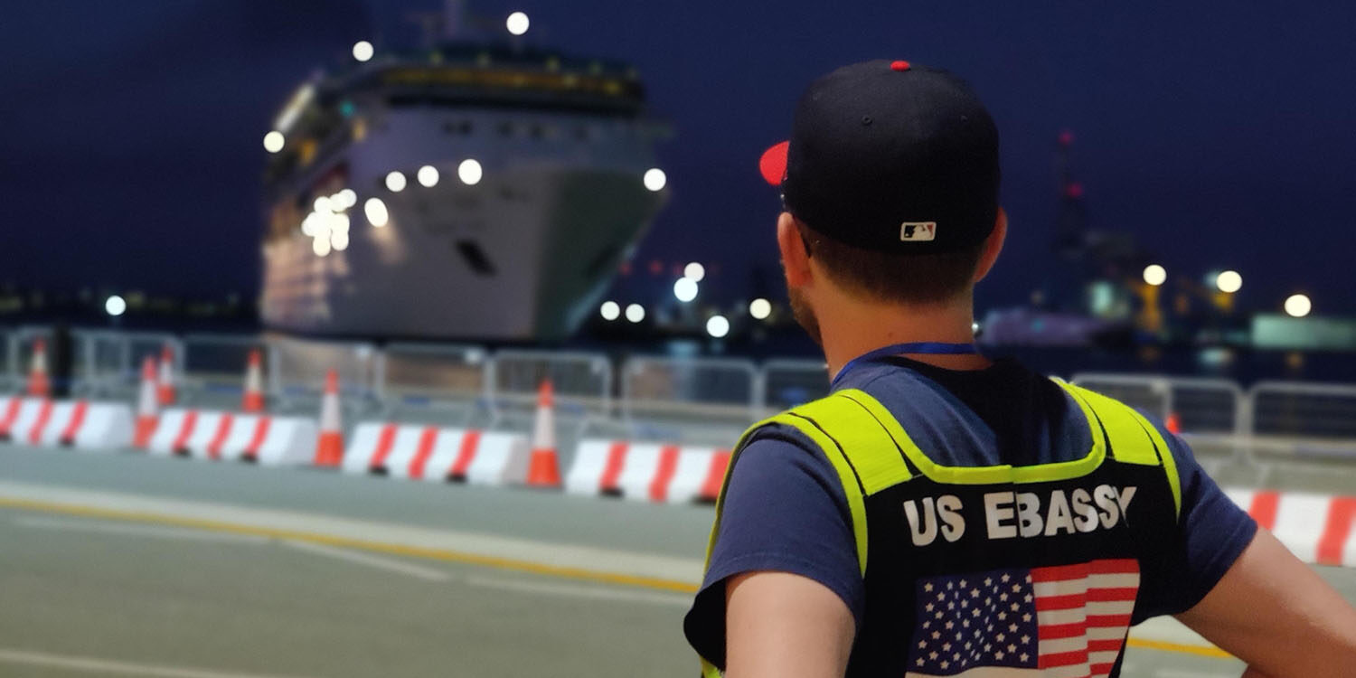 U.S. Embassy employee watches a ship with U.S. citizen passengers arrive in Cyprus from Israel.