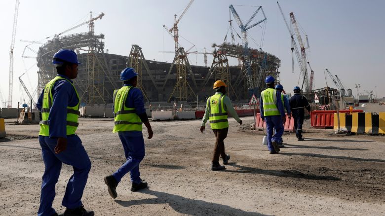 Workers walk to the Lusail Stadium, one of the 2022 World Cup stadiums, in Lusail, Qatar, on December 20, 2019.