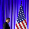 China’s President Xi Jinping passes a flag as he makes his way towards the podium at a dinner with business leaders.