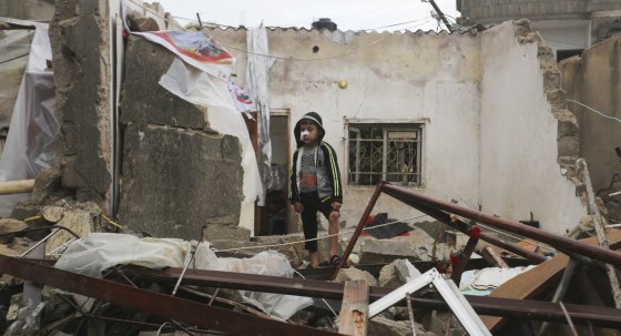 A Palestinian boy stands amid the rubble of his Rafah home (Image: AP/Hatem Ali)