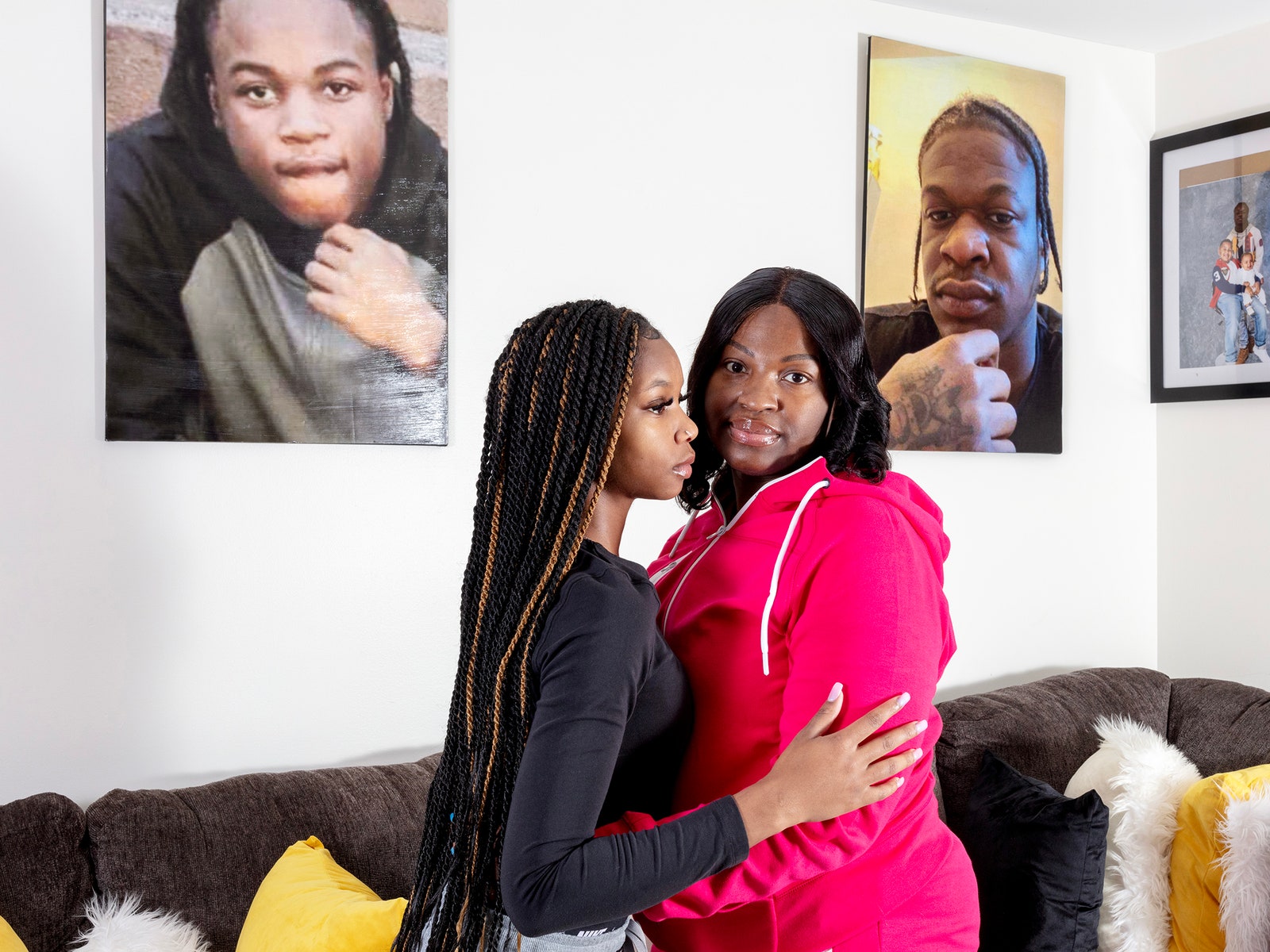 Two women embracing in a living room.