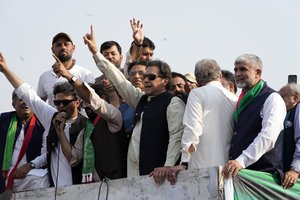 Pakistan's former Prime Minister Imran Khan, center, gestures to his supporters at a rally in Lahore, Pakistan, Saturday, Oct. 29 2022