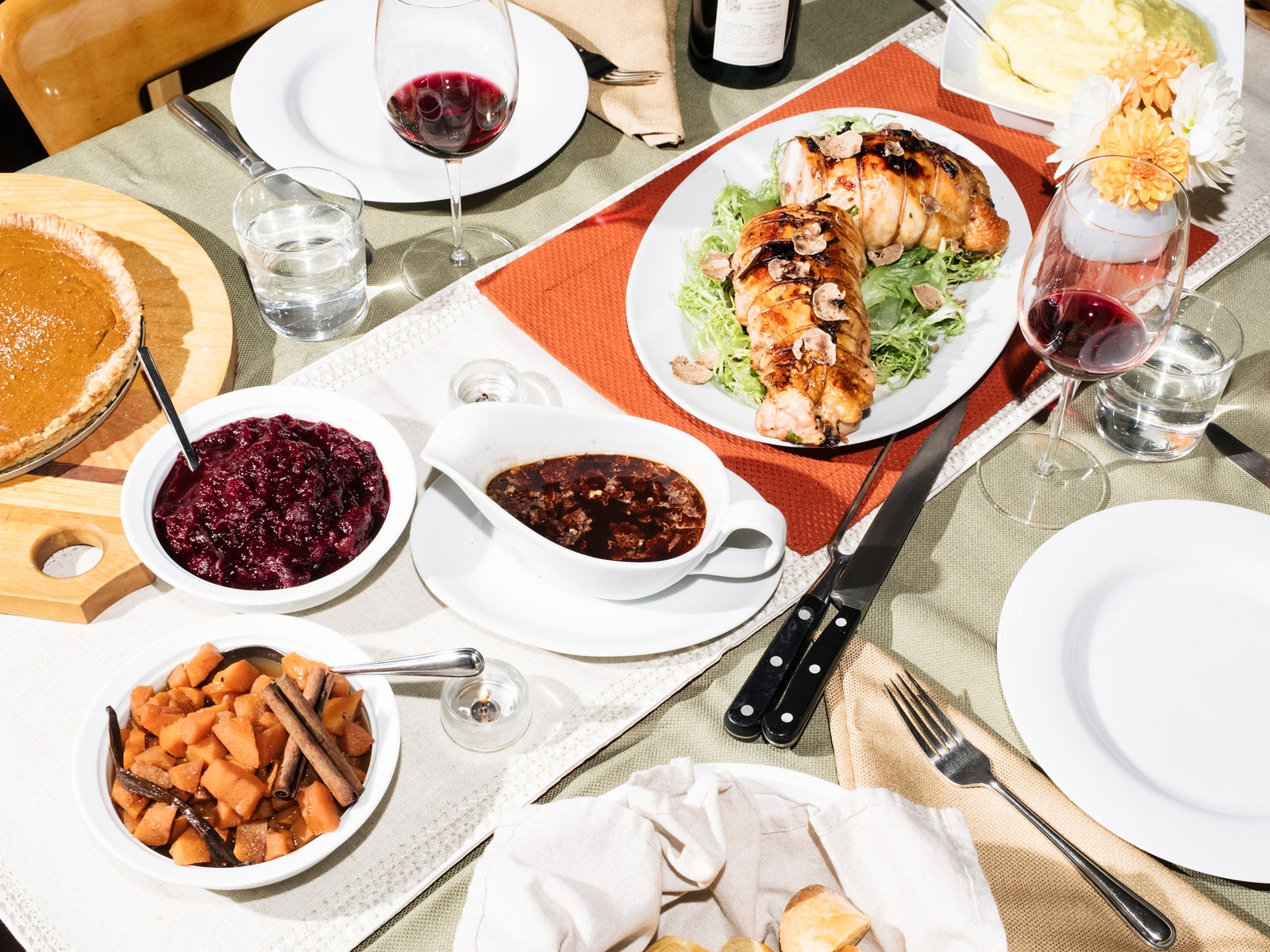 A main turkey dish and sauces fill a Thanksgiving table.