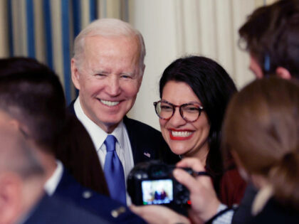 U.S. President Joe Biden (L) poses for photographs with Rep. Rashida Tlaib (D-MI) during the signing ceremony for the Postal Service Reform Act in the State Dining Room at the White House on April 06, 2022 in Washington, DC. A part of Postmaster General Louis DeJoy’s controversial 10-year restructuring plan, …