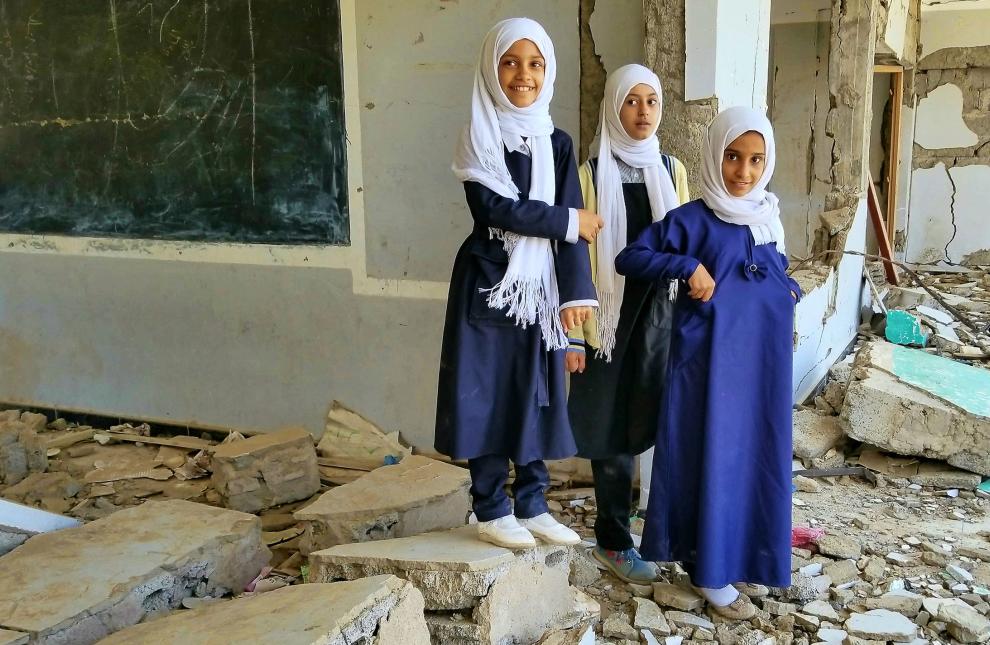 Students inspect their destroyed school in Taiz, Yemen. ANAS ALHAJJ/SHUTTERSTOCK