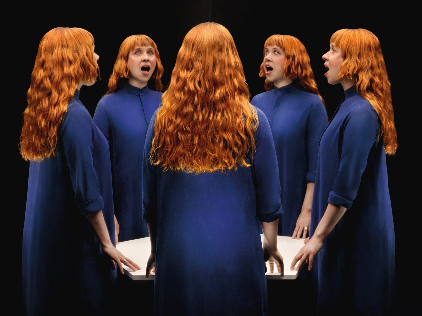 Many repeating images of Holly Herndon wearing a long blue dress.