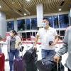 Balmore and other beneficiaries of the H-2 visa program do their check-in process at the Salvadoran international airport.