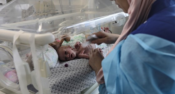Health personnel prepare premature babies to be transferred to Egypt after they were evacuated from Gaza’s Al-Shifa Hospital (Image: AAP/EPA/Haitham Imad)