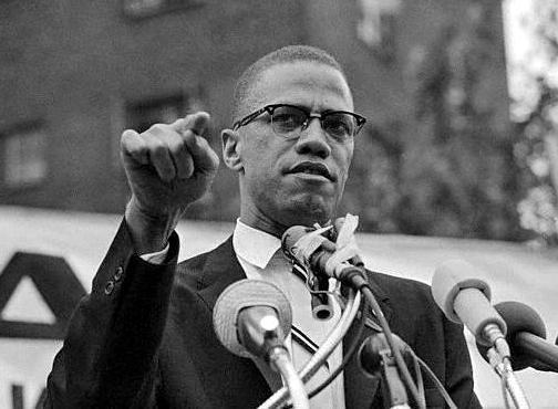 Malcolm X speaking to a crowd in Harlem