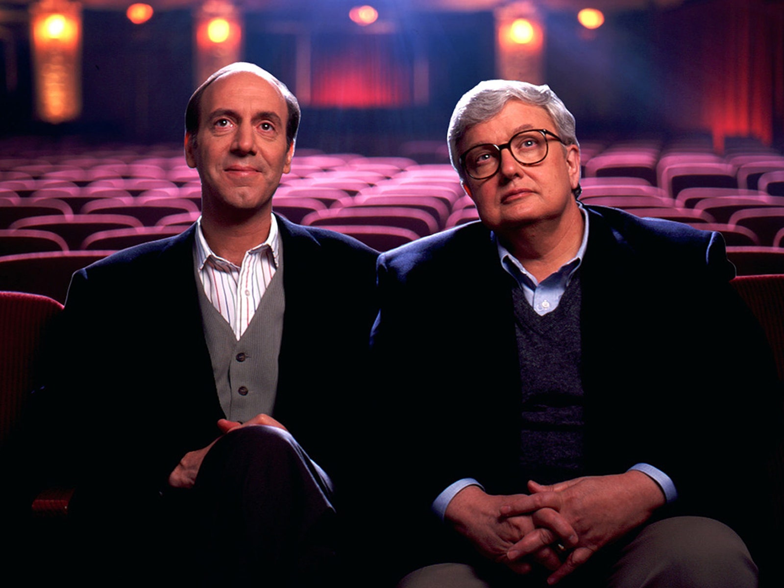A photo of Gene Siskel and Roger Ebert sitting together in a movie theatre.