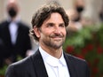 Bradley Cooper wearing a dark blazer and a white collared shirt.