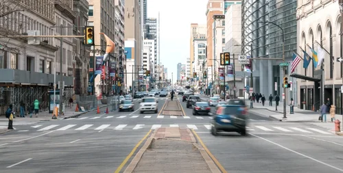 Image of cars and people moving through a city intersection