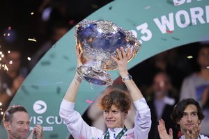 Italy's Jannik Sinner lifts a trophy after the Italian Davis Cup team defeated Australia during the Davis Cup final tennis matches in Malaga, Spain, Sunday, Nov. 26, 2023