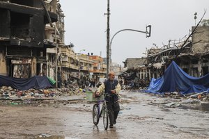 A Palestinian walks in Gaza City on Monday, Nov. 27, 2023. on the fourth day of the temporary ceasefire between Hamas and Israel.