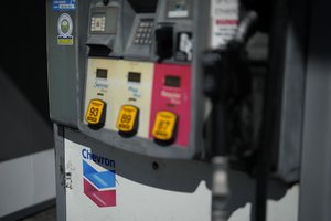 Signage is seen at a Chevron gas station, Monday, Oct. 23, 2023, in South Miami