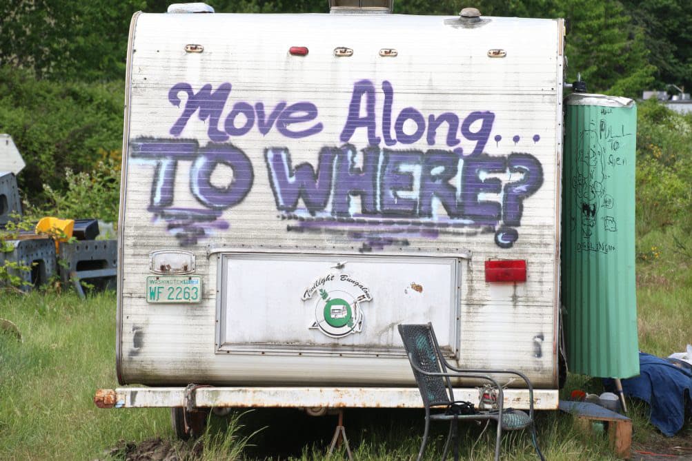 Camper/RV spray painted with the message "move along TO WHERE?"