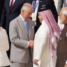 King Charles III greets fellow heads of state as he prepares for a family photo during day one of the COP28 Climate Conference in Dubai.