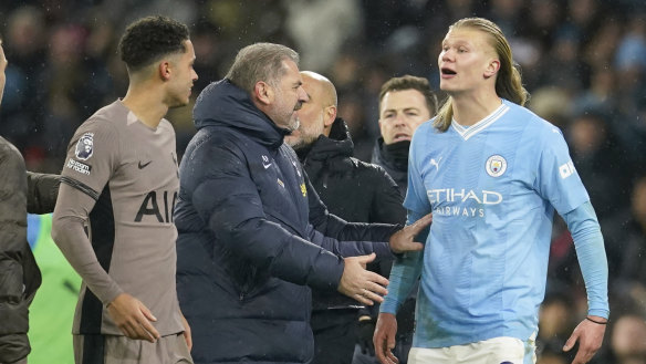 Ange Postecoglou holds back an angry Erling Haaland at the end of the match.