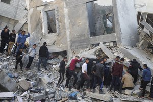 Palestinians look for survivors of the Israeli bombardment of the Gaza Strip in Rafah, Sunday, Dec. 3, 2023.