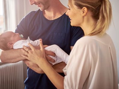 Shot of a happy young couple bonding with their baby girl at home