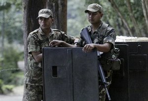 Nepalese soldiers stand guard outside the Nagarjuna forest palace gate, where King Gyanendra is believed to be staying in Katmandu, Nepal, Sunday, May 25, 2008