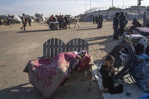 Palestinians displaced by the Israeli bombardment of the Gaza Strip gather at a tent camp, in Rafah, southern Gaza strip, Monday, Dec. 4, 2023. Hundreds of thousands of Palestinians have fled their homes as Israel moves ahead with a ground offensive against the ruling Hamas militant group.