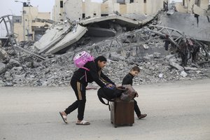 Palestinians fleeing the Israeli ground offensive arrive in Rafah, Gaza Strip, Tuesday, Dec. 5, 2023.