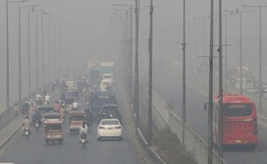 Vehicle drives on a highway as smog envelops the area of Lahore, Pakistan, Wednesday, Nov. 11, 2020.