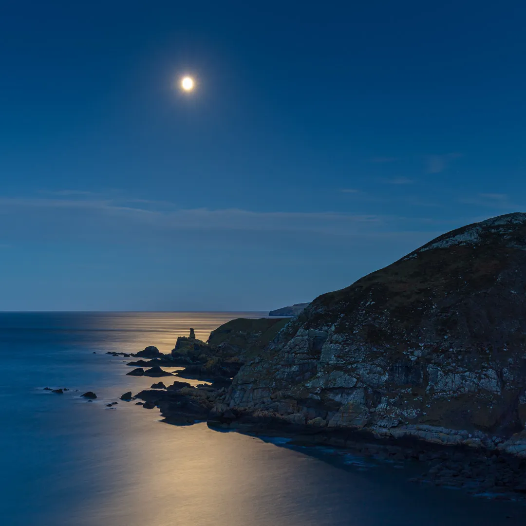 Full moon above The Souter, a sea stack near Fast Castle, Scottish Borders, Scotland.