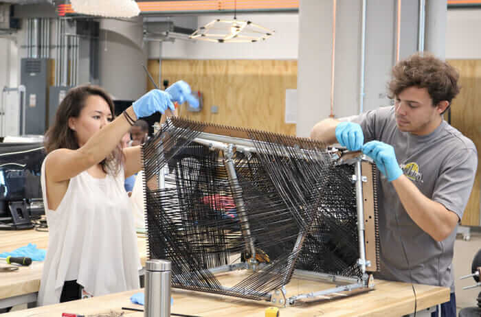 Project team hand weaving new carbon fiber architecture