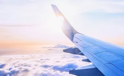 airplane wing in cloud scape