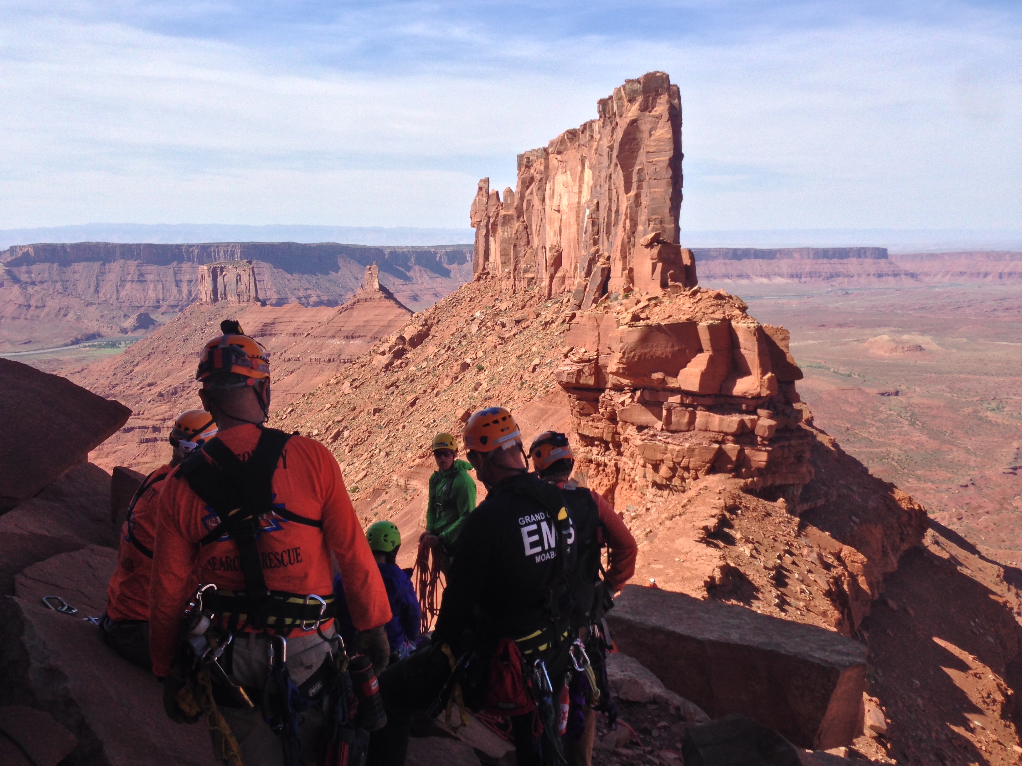 Rescue team assembled on the wall with iconic redrock spires in the background