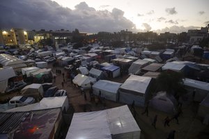 Palestinians displaced by the Israeli bombardment of the Gaza Strip are seen in tents in town of Khan Younis, Wednesday, Dec. 13, 2023.