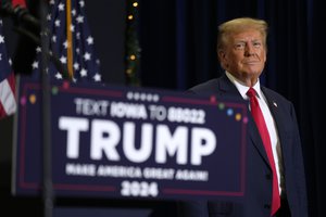 Former President Donald Trump greets supporters as he arrives at a commit to caucus rally, Tuesday, Dec. 19, 2023, in Waterloo, Iowa.